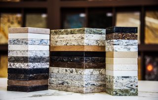 Quartz and granite countertop samples displayed in AMC Stone and Cabinets showroom