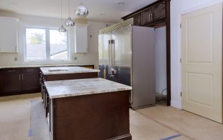 Prefabricated and full slab granite countertops installed in a Colorado kitchen by AMC Stone and Cabinets